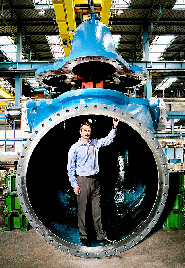 ANDRITZ employee demonstrating the size of a pump draft tube for Beijing_ China